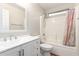 Bathroom with white vanity, shower/tub combo, and window at 12750 W Hollyhock Dr, Avondale, AZ 85392