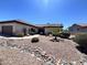 Charming single-story home featuring a low-maintenance desert landscape with decorative rocks and a pathway to the front door at 18326 N Gila Springs Dr, Surprise, AZ 85374