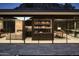 Elegant bar area with fully stocked shelves, glass windows, and a cozy fireplace in the living room at 4301 E Upper Ridge Way, Paradise Valley, AZ 85253