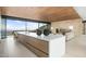Modern kitchen features a large island, sleek cabinets, and expansive windows showcasing scenic mountain views at 4301 E Upper Ridge Way, Paradise Valley, AZ 85253