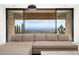 Comfortable living room with a large sectional sofa and a stunning view of the desert landscape and city skyline at 4301 E Upper Ridge Way, Paradise Valley, AZ 85253