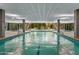 An indoor swimming pool, with stairs to the fitness center and views to the outdoors at 7141 E Rancho Vista Dr # 2011, Scottsdale, AZ 85251