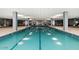 This indoor pool and spa features a mosaic tile border and is surrounded by columns and lounge chairs at 7141 E Rancho Vista Dr # 2011, Scottsdale, AZ 85251