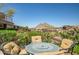 This beautiful patio with vibrant flowers and mountain views has a dining table with four chairs for enjoying the scenery at 7161 E Rancho Vista Dr # 6001, Scottsdale, AZ 85251