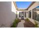 View down the walkway of the modern front door with sidelight windows, and a stone walkway at 21864 E Sunset Dr, Queen Creek, AZ 85142