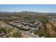 An aerial view of a community showcasing well-maintained homes, streets, and natural desert landscape at 2425 W Bronco Butte Trl # 1002, Phoenix, AZ 85085