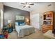 Comfortable bedroom with soft blue colors, carpet, and a decorative painted accent wall at 2425 W Bronco Butte Trl # 1002, Phoenix, AZ 85085