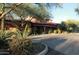 Clubhouse building framed by mature landscaping, including cactus, succulents, and shrubs at 2425 W Bronco Butte Trl # 1002, Phoenix, AZ 85085