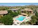 An aerial view of a community pool and spa with lounge chairs, perfect for relaxation and recreation at 2425 W Bronco Butte Trl # 1002, Phoenix, AZ 85085