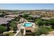 Beautiful community pool and lounge area surrounded by lush landscaping and well-maintained lawns at 2425 W Bronco Butte Trl # 1002, Phoenix, AZ 85085