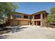 Spacious home exterior with a three-car garage, stone accents, and well-maintained landscaping at 2425 W Bronco Butte Trl # 1002, Phoenix, AZ 85085