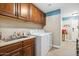 A functional laundry room with wooden cabinets and modern appliances, perfect for everyday chores at 2425 W Bronco Butte Trl # 1002, Phoenix, AZ 85085