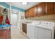 A functional laundry room with wooden cabinets and modern appliances, perfect for everyday chores at 2425 W Bronco Butte Trl # 1002, Phoenix, AZ 85085