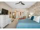 A relaxing main bedroom with stone accent wall, ceiling fan, and neutral colored carpet and decor at 2425 W Bronco Butte Trl # 1002, Phoenix, AZ 85085