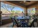 Charming outdoor patio with comfortable seating, wrought iron furniture, and views of the landscaped yard at 2425 W Bronco Butte Trl # 1002, Phoenix, AZ 85085