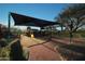 Playground features a covered slide, swings, and various climbing options surrounded by soft, sandy ground at 2425 W Bronco Butte Trl # 1002, Phoenix, AZ 85085