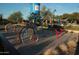 Community splash pad offers water features, including a playful fountain, colorful hoops, and nearby lounge chairs at 2425 W Bronco Butte Trl # 1002, Phoenix, AZ 85085