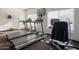 Bright workout room featuring treadmills, stationary bike, and natural light from large windows at 2425 W Bronco Butte Trl # 1002, Phoenix, AZ 85085