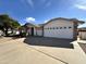 Charming single-story home with a three car garage and a well-maintained front yard at 8217 E Natal Ave, Mesa, AZ 85209