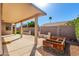 Covered patio and wooden garden planters offer a relaxing outdoor space in this backyard at 1451 E Palm Beach Dr, Chandler, AZ 85249