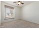 Bedroom with carpet flooring and a window featuring blinds and floral valances for added privacy at 1451 E Palm Beach Dr, Chandler, AZ 85249