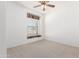 Clean bedroom features neutral carpet flooring, and bright window at 1451 E Palm Beach Dr, Chandler, AZ 85249