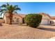 Charming single-story home with desert landscaping, mature palm tree, and attached two-car garage at 1451 E Palm Beach Dr, Chandler, AZ 85249