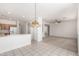 Open kitchen featuring tile flooring, white appliances, and a breakfast bar at 1451 E Palm Beach Dr, Chandler, AZ 85249
