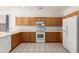 Spacious kitchen features tile flooring, ample cabinet storage, and white appliances at 1451 E Palm Beach Dr, Chandler, AZ 85249