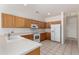Functional kitchen featuring tile floors, oak cabinets, and white appliances at 1451 E Palm Beach Dr, Chandler, AZ 85249