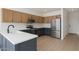 Modern kitchen featuring stainless steel appliances, light wood floors, and blue accents at 1451 E Palm Beach Dr, Chandler, AZ 85249