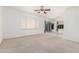 Bright living room features neutral paint, carpet flooring, ceiling fan, and natural light at 1451 E Palm Beach Dr, Chandler, AZ 85249