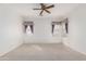 Spacious main bedroom features carpet flooring, a ceiling fan, and decorative window treatments at 1451 E Palm Beach Dr, Chandler, AZ 85249