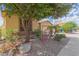 Landscaped yard with mature trees and drought-tolerant plants at 18009 W Ivy Ln, Surprise, AZ 85388