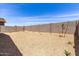 This backyard features desert landscaping and a tall block wall, offering privacy and low maintenance at 18162 W Cielo Grande Ave, Surprise, AZ 85387