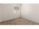 This bedroom features plush carpeting and a window with blinds at 18162 W Cielo Grande Ave, Surprise, AZ 85387