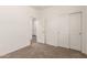 This bedroom includes plush carpeting, a closet, and neutral walls at 18162 W Cielo Grande Ave, Surprise, AZ 85387