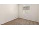 Bedroom featuring a window, carpet, and a fresh coat of white paint at 18162 W Cielo Grande Ave, Surprise, AZ 85387