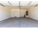This garage is spacious with concrete flooring and a white door at 18162 W Cielo Grande Ave, Surprise, AZ 85387