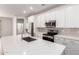 Spacious kitchen with white cabinets, stainless steel appliances, and large island at 18162 W Cielo Grande Ave, Surprise, AZ 85387