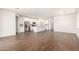 Open-concept living space with wood-look tile flooring and abundant natural light at 18162 W Cielo Grande Ave, Surprise, AZ 85387