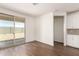 Bright living room showcasing sliding glass door and connection to the kitchen at 18162 W Cielo Grande Ave, Surprise, AZ 85387