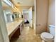 Bathroom featuring dual sinks, tile flooring and a combined shower tub at 23200 W Ashleigh Marie Dr, Buckeye, AZ 85326