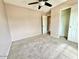 This bedroom features neutral carpeting and a ceiling fan at 23200 W Ashleigh Marie Dr, Buckeye, AZ 85326