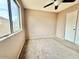 Bedroom featuring natural lighting, a ceiling fan and a closet with folding doors at 23200 W Ashleigh Marie Dr, Buckeye, AZ 85326