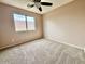 Bedroom featuring natural light, a ceiling fan and neutral colored walls at 23200 W Ashleigh Marie Dr, Buckeye, AZ 85326