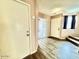 Inviting entryway with wood-like floors, neutral paint, and access to other rooms and staircase at 23200 W Ashleigh Marie Dr, Buckeye, AZ 85326