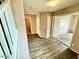 Inviting entryway with wood-like floors, neutral paint, and access to a bathroom and a bedroom at 23200 W Ashleigh Marie Dr, Buckeye, AZ 85326