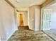 Inviting entryway with wood-like floors, neutral paint, and access to a bathroom and a bedroom at 23200 W Ashleigh Marie Dr, Buckeye, AZ 85326