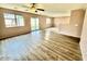 Living room featuring hard surface floors, two windows, and a sliding glass door with backyard access at 23200 W Ashleigh Marie Dr, Buckeye, AZ 85326